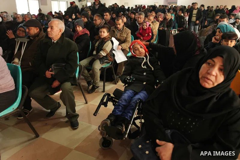 Palestinians wait for travel permits to cross into Egypt through the Rafah border crossing after it was opened by Egyptian authorities for humanitarian cases, in Rafah in the southern Gaza Strip December 17, 2016. Photo...