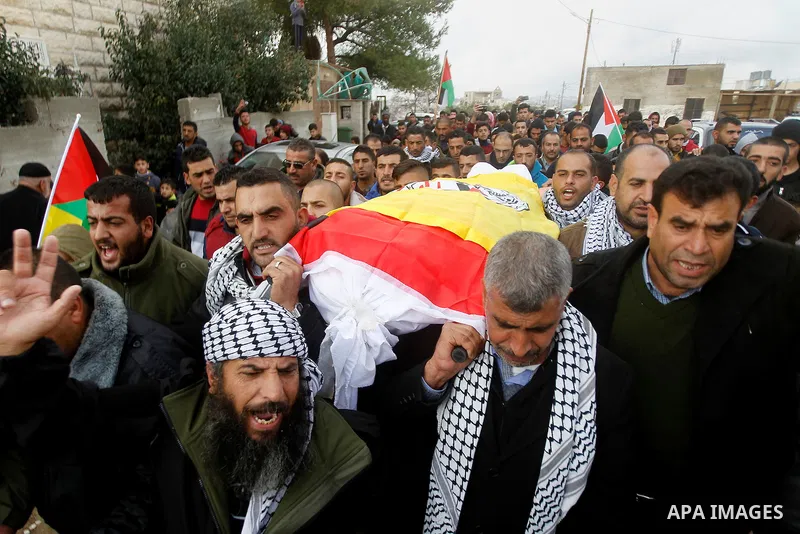 Mourners carry the body of Palestinian Sara Tarayra Hjoj, who according to the Israeli military was shot dead by Israeli police after she tried to stab one of them last July, after Israel released her body, in the West B...