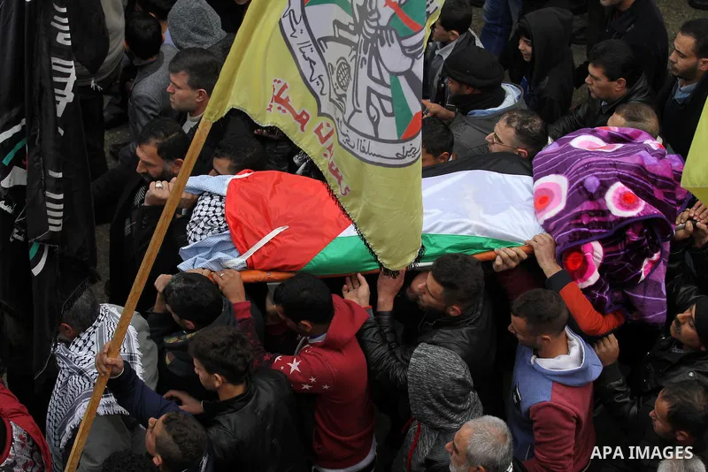 Mourners carry the body of Palestinian Rahiq Birawi, who according to the Israeli police was shot dead after she had advanced towards them with a knife in her hand at a checkpoint last October, during her funeral after I...