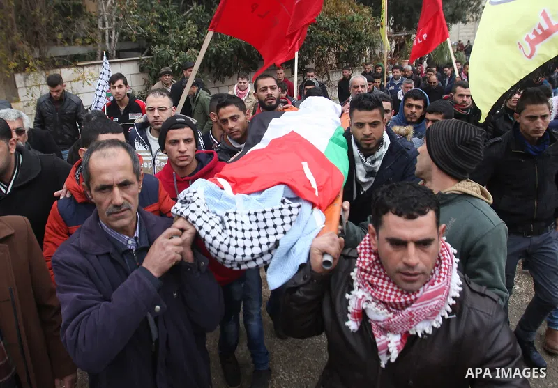 Mourners carry the body of Palestinian Rahiq Birawi, who according to the Israeli police was shot dead after she had advanced towards them with a knife in her hand at a checkpoint last October, during her funeral after I...