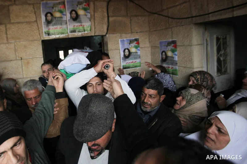 Mourners carry the body of Palestinian Rahiq Birawi, who according to the Israeli police was shot dead after she had advanced towards them with a knife in her hand at a checkpoint last October, during her funeral after I...