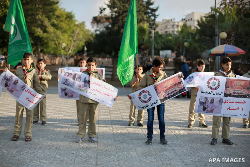 Palestinain Scouts take part in a protest to solidarity with the inhabitants of the embattled Syrian city of Aleppo, in Gaza city, on December 17, 2016. Photo by Mohammed Asad