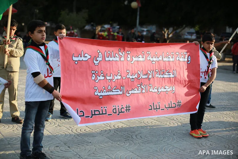 Palestinain Scouts take part in a protest to solidarity with the inhabitants of the embattled Syrian city of Aleppo, in Gaza city, on December 17, 2016. Photo by Mohammed Asad