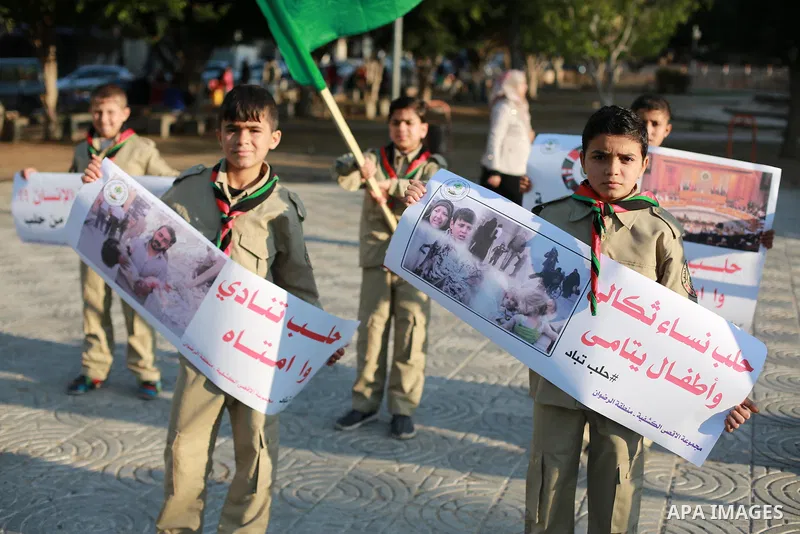 Palestinain Scouts take part in a protest to solidarity with the inhabitants of the embattled Syrian city of Aleppo, in Gaza city, on December 17, 2016. Photo by Mohammed Asad