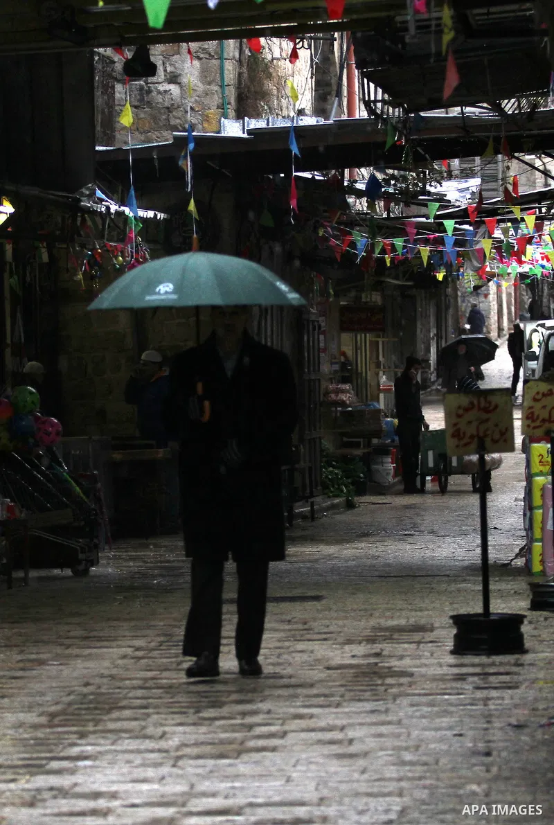 A Palestinian man walks with his umbrella under the rain, during a winter storm, in the West Bank city of Nablus, on December 18, 2016. Photo by Nedal Eshtayah
