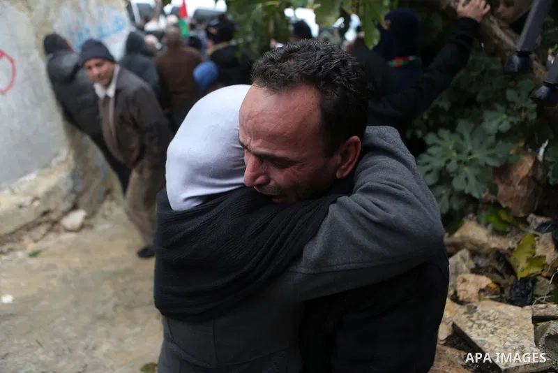 Relatives of Palestinian Ahmed al-Remawi, who Palestinian Health Ministry said was shot and killed by Israeli forces on Sunday, mourn during his funeral in the West Bank village of Beit Rima near Ramallah December 18, 20...