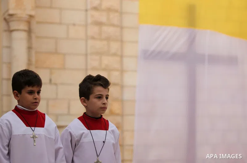 Palestinian altar boys wait await the arrival of English cardinal Vincent Nichols, Archbishop of Westminster, to lead a Sunday mass at Der Latin church in Gaza City on December 18, 2016. Photo by Ashraf Amra