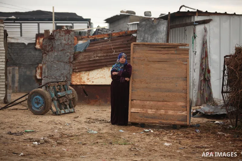 A Palestinian woman stands outside her dwellings in Khan Younis in the southern Gaza Strip December 19, 2016. Photo by Ashraf Amra