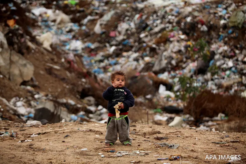 A Palestinian child stand outside his dwelling covered with plastic sheet in Khan Younis in the southern Gaza Strip December 19, 2016. Photo by Ashraf Amra