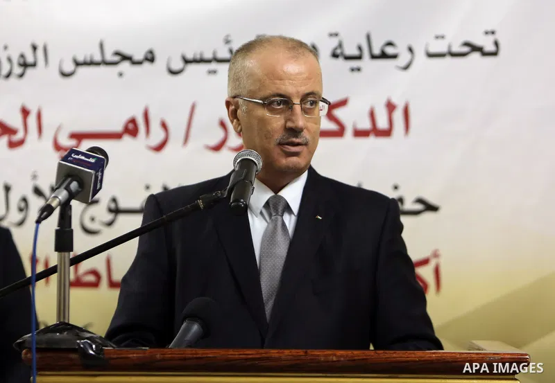 Palestinian Prime Minister Rami Hamdallah speaks during the graduation ceremony of the first group of Palestinian officers academy students, in the West Bank city of Jericho, on December 19, 2016. Photo by Prime Minister...