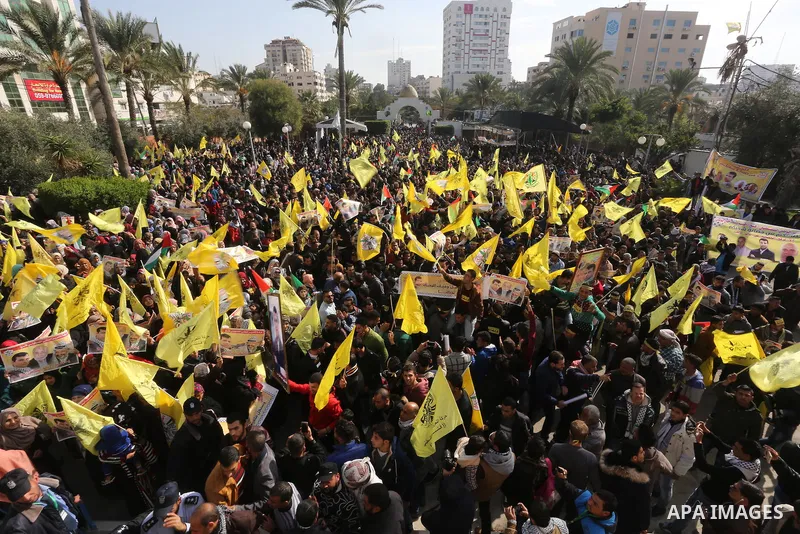 Palestinian supporters Fatah movement take part during a protest against the decision of the Palestinian President Mahmoud Abbas to strip members from Fatah of their Parliamentary Immunity, in Gaza city, on December 22,...