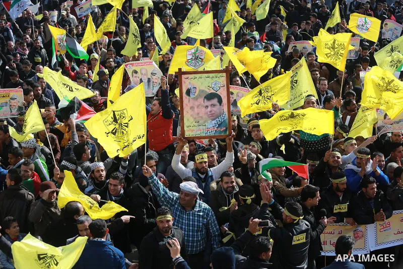 Palestinian supporters Fatah movement take part during a protest against the decision of the Palestinian President Mahmoud Abbas to strip members from Fatah of their Parliamentary Immunity, in Gaza city, on December 22,...