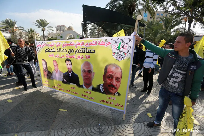 Palestinian supporters Fatah movement take part during a protest against the decision of the Palestinian President Mahmoud Abbas to strip members from Fatah of their Parliamentary Immunity, in Gaza city, on December 22,...