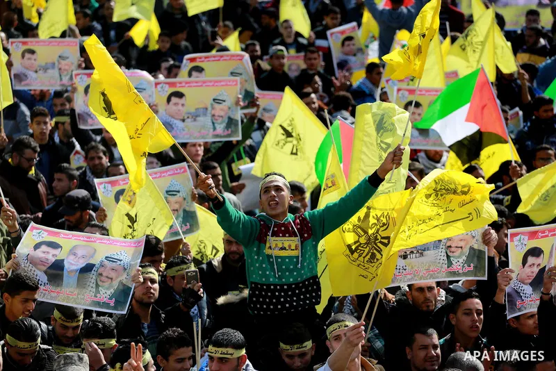 Palestinian supporters Fatah movement take part during a protest against the decision of the Palestinian President Mahmoud Abbas to strip members from Fatah of their Parliamentary Immunity, in Gaza city, on December 22,...