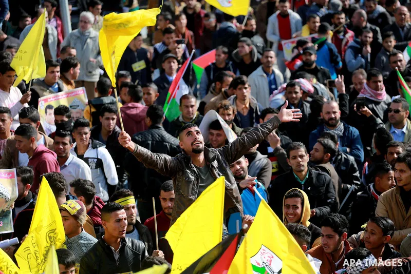 Palestinian supporters Fatah movement take part during a protest against the decision of the Palestinian President Mahmoud Abbas to strip members from Fatah of their Parliamentary Immunity, in Gaza city, on December 22,...