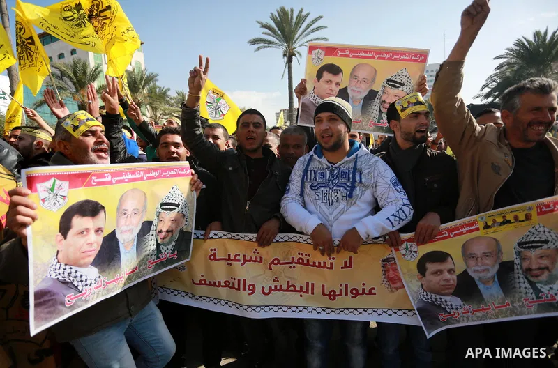 Palestinian supporters Fatah movement take part during a protest against the decision of the Palestinian President Mahmoud Abbas to strip members from Fatah of their Parliamentary Immunity, in Gaza city, on December 22,...