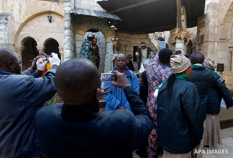 Africans Christian pilgrims visit the Church of the Nativity, revered as the site of Jesus Christ's birth, on December 22, 2016 in the biblical West Bank town of Bethlehem. Photo by Wisam Hashlamoun