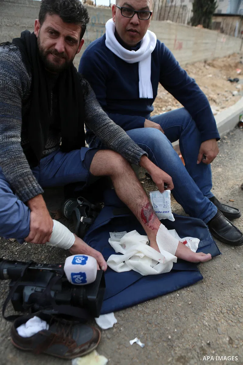 A Palestinian cameraman is evacuated After his injury during clashes with Israeli border guard at a demonstration next to a section of Israel's separation wall in the biblical town of Bethlehem, in the occupied West Bank...