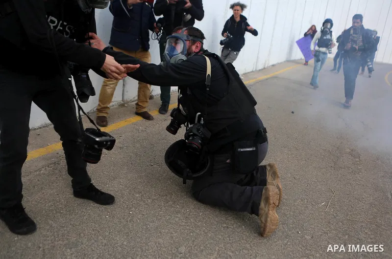 A Palestinian Photographer is evacuated after inhaling tear grenade fired by Israeli border guard during clashes at a demonstration next to a section of Israel's separation wall in the biblical town of Bethlehem, in the...
