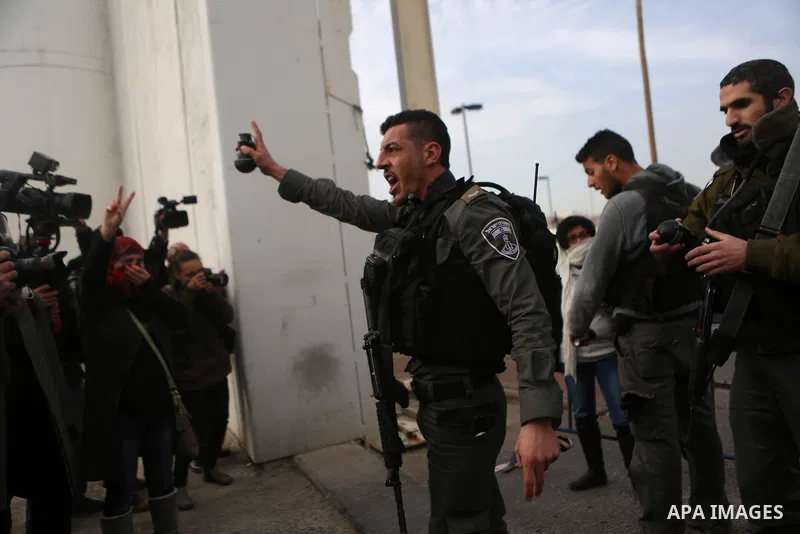 Palestinian protesters argue with an Israeli border guard during clashes at a demonstration next to a section of Israel's separation wall in the biblical town of Bethlehem, in the occupied West Bank, on December 23, 2016...