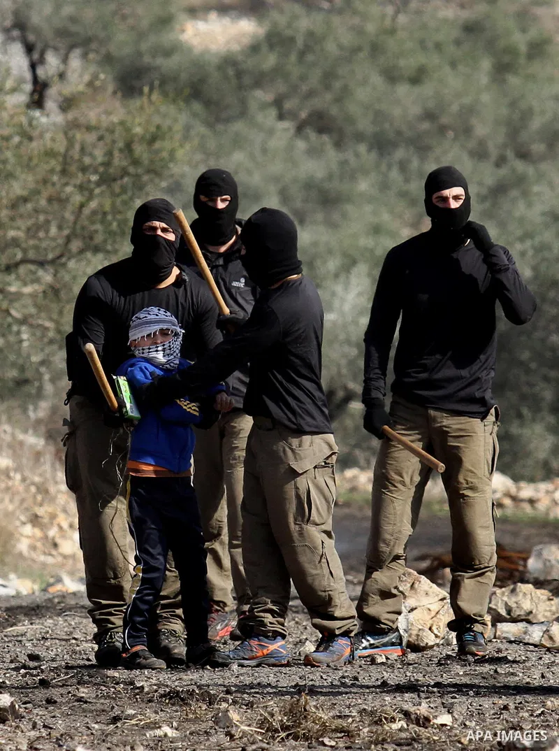 Masked members of the Israeli security forces briefly detain a Palestinian boy during clashes following a demonstration against the expropriation of Palestinian land by Israel in the village of Kfar Qaddum, near Nablus,...