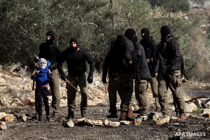 Masked members of the Israeli security forces briefly detain a Palestinian boy during clashes following a demonstration against the expropriation of Palestinian land by Israel in the village of Kfar Qaddum, near Nablus,...