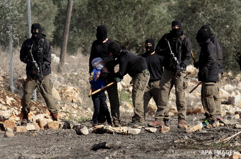 Masked members of the Israeli security forces briefly detain a Palestinian boy during clashes following a demonstration against the expropriation of Palestinian land by Israel in the village of Kfar Qaddum, near Nablus,...