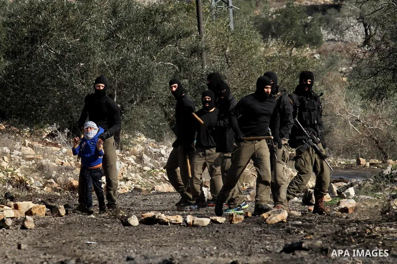 Masked members of the Israeli security forces briefly detain a Palestinian boy during clashes following a demonstration against the expropriation of Palestinian land by Israel in the village of Kfar Qaddum, near Nablus,...