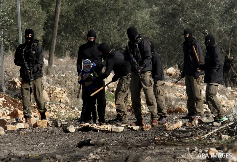 Masked members of the Israeli security forces briefly detain a Palestinian boy during clashes following a demonstration against the expropriation of Palestinian land by Israel in the village of Kfar Qaddum, near Nablus,...