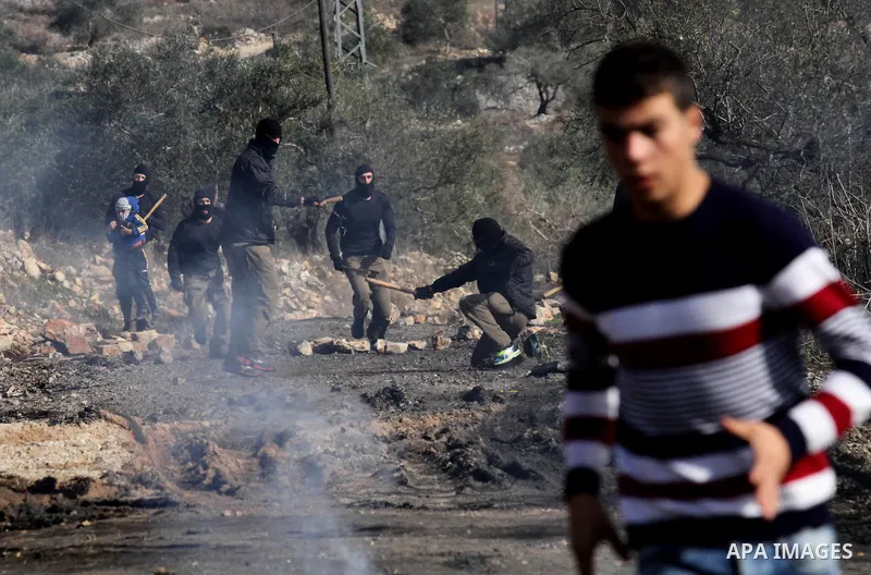 Masked members of the Israeli security forces briefly detain a Palestinian boy during clashes following a demonstration against the expropriation of Palestinian land by Israel in the village of Kfar Qaddum, near Nablus,...