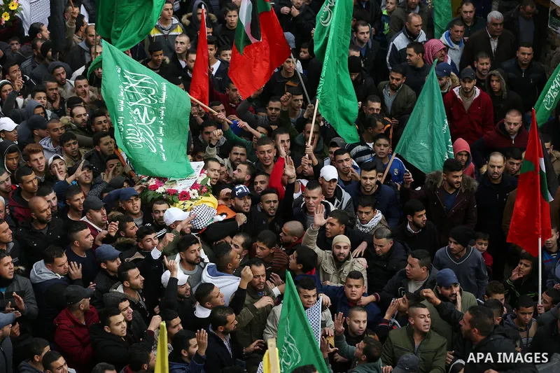 Palestinians carry the body of Fares al-Bayed, 16, who was shot and injured during clashes with Israeli soldiers in last October during his funeral, in the West Bank city of Ramallah, on December 23, 2016. Al-Bayed was c...