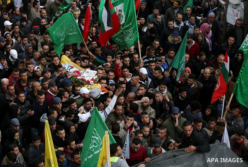 Palestinians carry the body of Fares al-Bayed, 16, who was shot and injured during clashes with Israeli soldiers in last October during his funeral, in the West Bank city of Ramallah, on December 23, 2016. Al-Bayed was c...