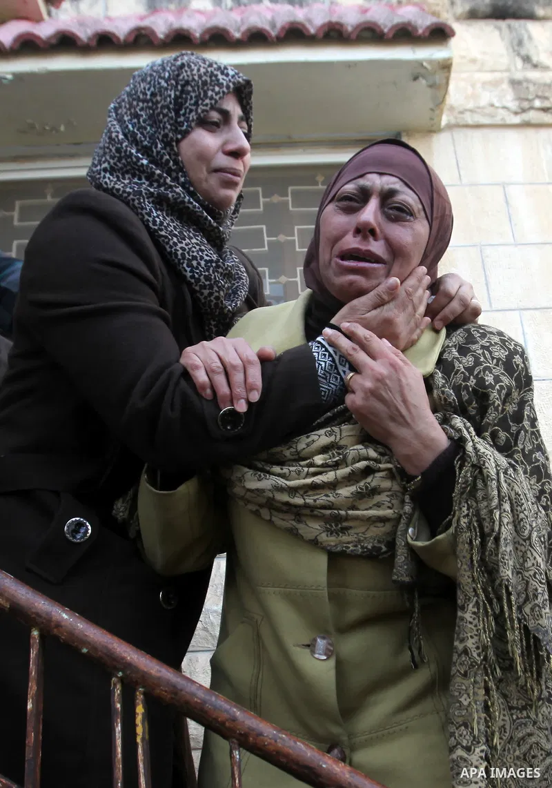 Relatives of Palestinian Jihad Khalil, who according to the Israeli police was shot and killed by an Israeli security guard after Khalil tried to stab him last November, mourn during his funeral after Israel released his...