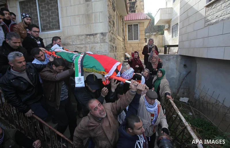 Mourners carry the body of Palestinian Jihad Khalil, who according to the Israeli police was shot and killed by an Israeli security guard after Khalil tried to stab him last November, during his funeral after Israel rele...