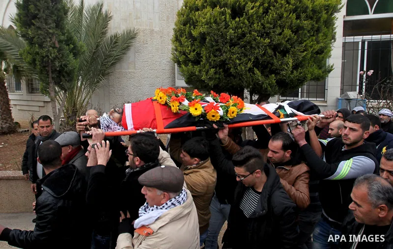 Mourners carry the body of Palestinian Jihad Khalil, who according to the Israeli police was shot and killed by an Israeli security guard after Khalil tried to stab him last November, during his funeral after Israel rele...