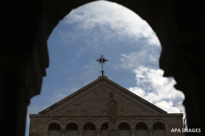 A Cross of the Church of the Nativity in seen as people gather for Christmas celebrations in the city of Bethlehem in the Israeli-occupied West Bank, on December 24, 2016. Photo by Shadi Hatem