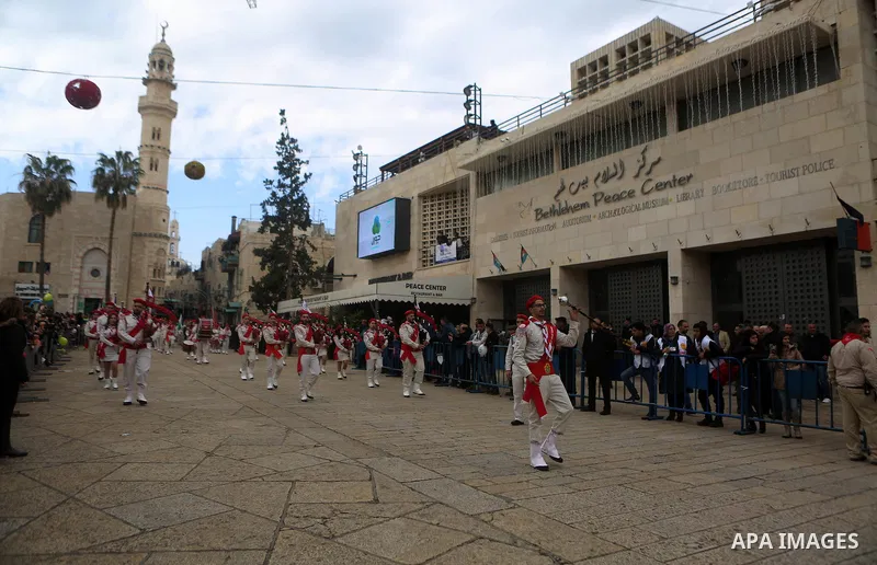 Palestinian Christian scouts perform at the Manger Square outside the Church of the Nativity as people gather for Christmas celebrations in the city of Bethlehem in the Israeli-occupied West Bank, on December 24, 2016. P...