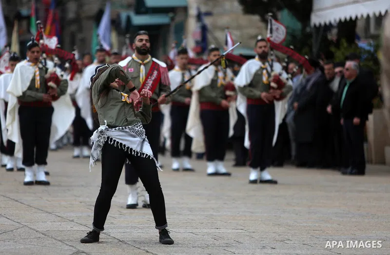 Palestinian Christian scouts perform at the Manger Square outside the Church of the Nativity as people gather for Christmas celebrations in the city of Bethlehem in the Israeli-occupied West Bank, on December 24, 2016. P...