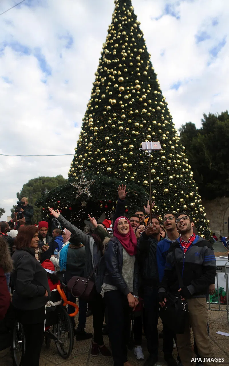 Palestinians attend a Christian scouts performance at the Manger Square outside the Church of the Nativity during Christmas celebrations in the city of Bethlehem in the Israeli-occupied West Bank, on December 24, 2016. P...
