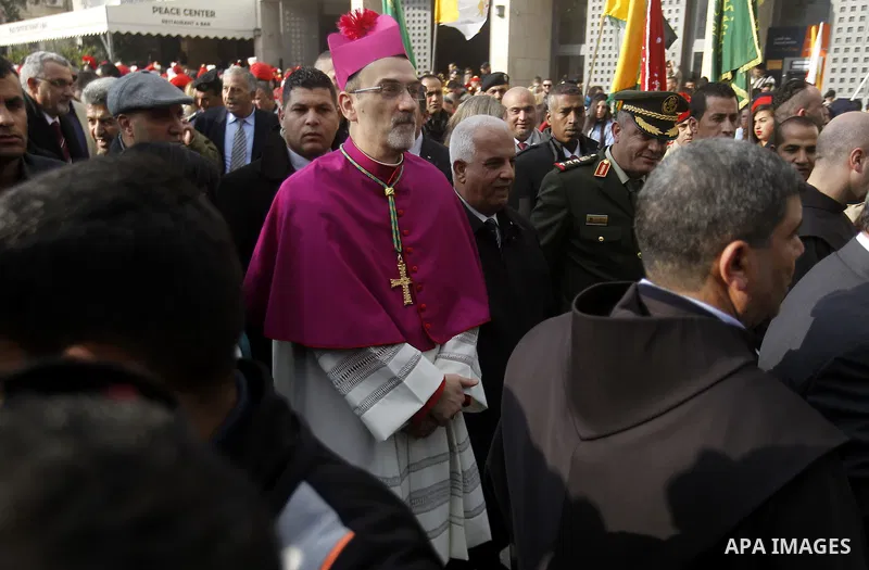The Latin Patriarch of Jerusalem Pierbattista Pizzaballa is greeted upon his arrival through an Israeli checkpoint to attend Christmas celebrations, in the West Bank city of Bethlehem December 24, 2016. Photo by Wisam Ha...