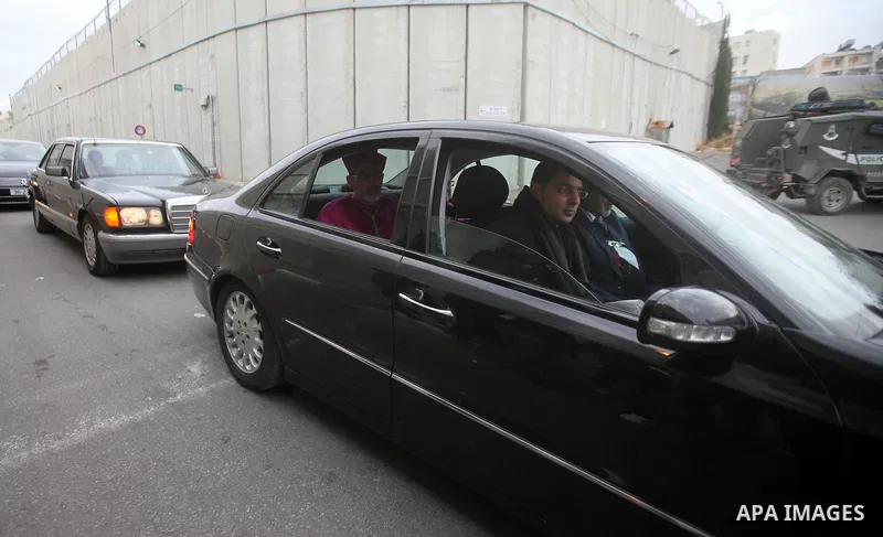 The Latin Patriarch of Jerusalem Pierbattista Pizzaballa is greeted upon his arrival through an Israeli checkpoint to attend Christmas celebrations, in the West Bank city of Bethlehem December 24, 2016. Photo by Wisam Ha...
