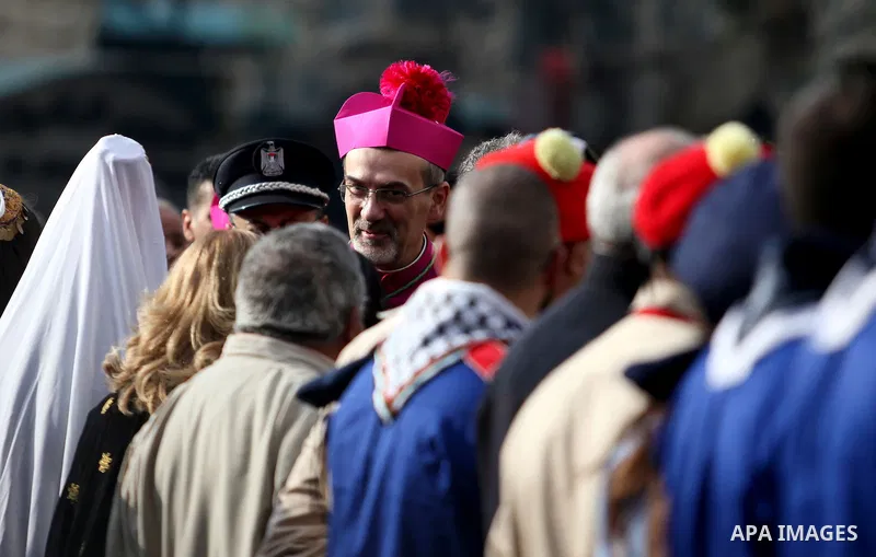 The Latin Patriarch of Jerusalem Pierbattista Pizzaballa is greeted upon his arrival through an Israeli checkpoint to attend Christmas celebrations, in the West Bank city of Bethlehem December 24, 2016. Photo by Wisam Ha...