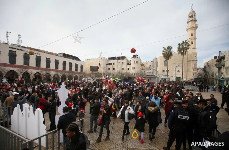 The Latin Patriarch of Jerusalem Pierbattista Pizzaballa is greeted upon his arrival through an Israeli checkpoint to attend Christmas celebrations, in the West Bank city of Bethlehem December 24, 2016. Photo by Wisam Ha...