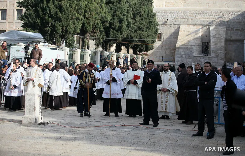 Clergymen wait for the arrival of the Latin Patriarch of Jerusalem Pierbattista Pizzaballa during Christmas celebrations, outside the Church of the Nativity in the West Bank city of Bethlehem December 24, 2016. Photo by...