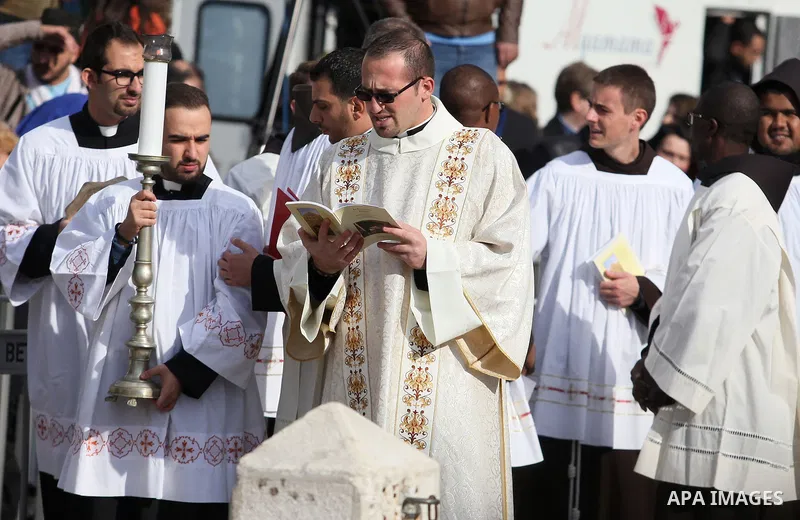 Clergymen wait for the arrival of the Latin Patriarch of Jerusalem Pierbattista Pizzaballa during Christmas celebrations, outside the Church of the Nativity in the West Bank city of Bethlehem December 24, 2016. Photo by...