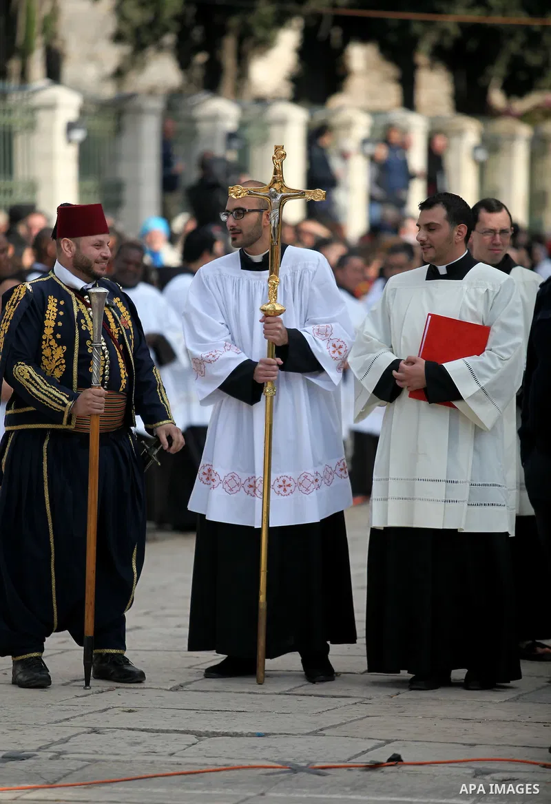 Clergymen wait for the arrival of the Latin Patriarch of Jerusalem Pierbattista Pizzaballa during Christmas celebrations, outside the Church of the Nativity in the West Bank city of Bethlehem December 24, 2016. Photo by...