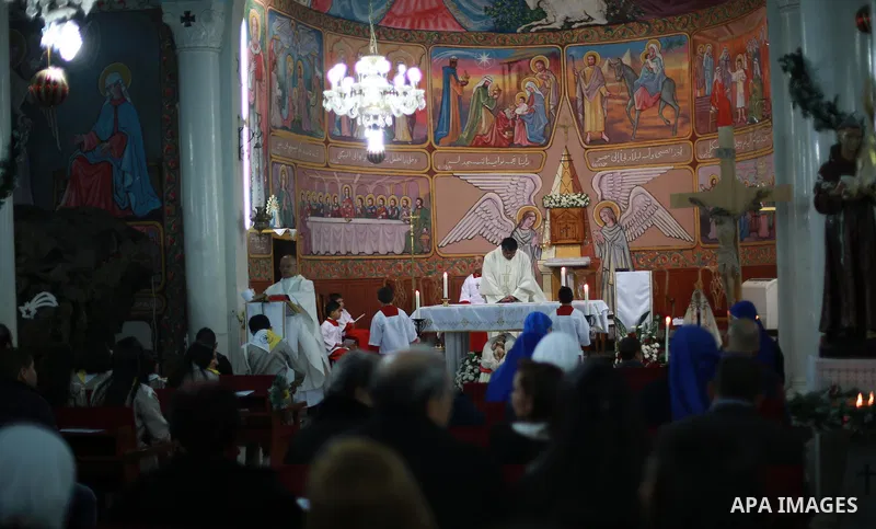 Palestinian Christians attend Christmas mass at the Holy Family Church, in Gaza City on December 24, 2016. Photo by Mohammed Asad