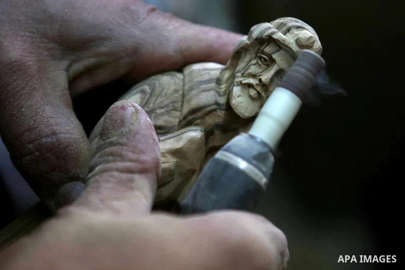 A Palestinian carpenter carves a wooden effigies of the the Holy Family at a workshop in the West Bank town of Bethlehem, on December 26, 2016. The traditional birthplace of Jesus Christ prepares to celebrate Christmas....