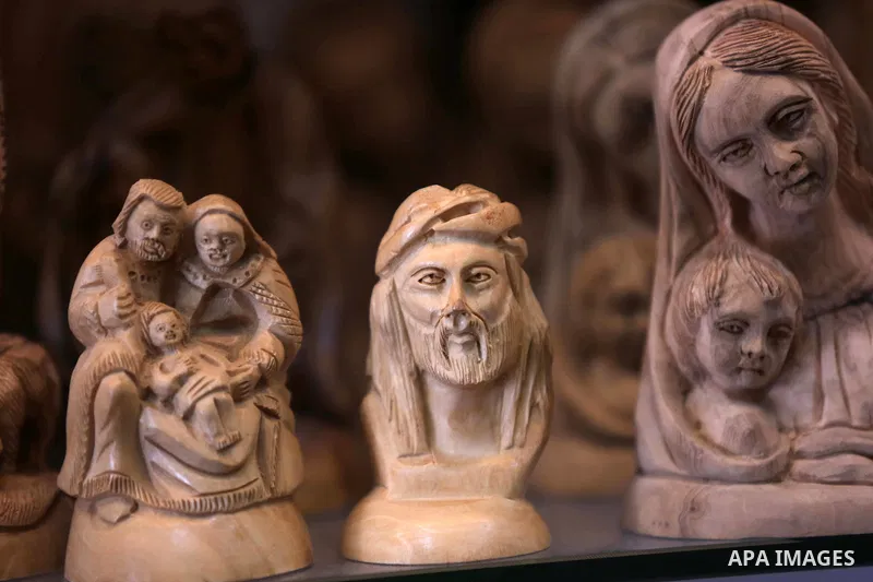 A woden effigies of the the Holy Family are seen at a workshop in the West Bank town of Bethlehem, on December 26, 2016. The traditional birthplace of Jesus Christ prepares to celebrate Christmas. Photo by Shadi Hatem