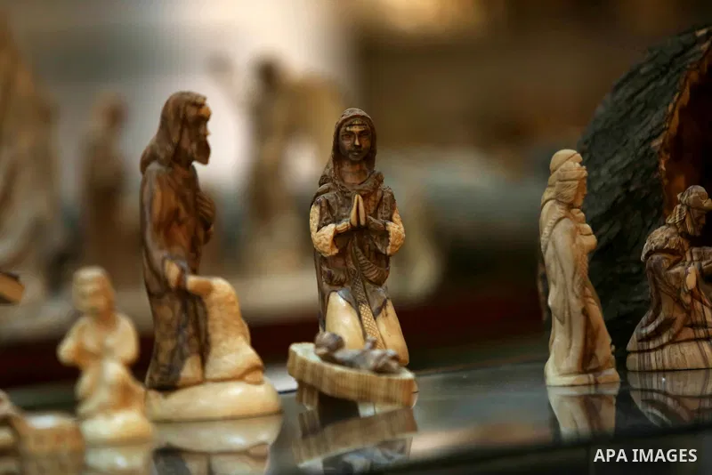 A woden effigies of the the Holy Family are seen at a workshop in the West Bank town of Bethlehem, on December 26, 2016. The traditional birthplace of Jesus Christ prepares to celebrate Christmas. Photo by Shadi Hatem